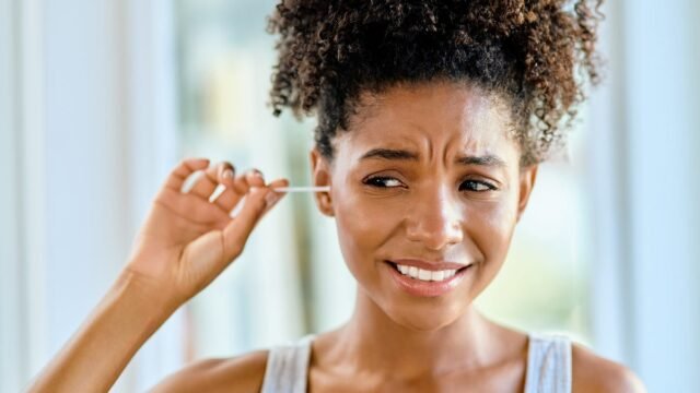 person-cleaning-ear-q-tip.jpg